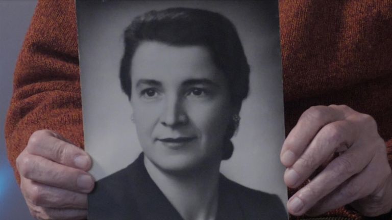 Albert Reiss holds up a photo of the Catholic woman who pretended he was her son