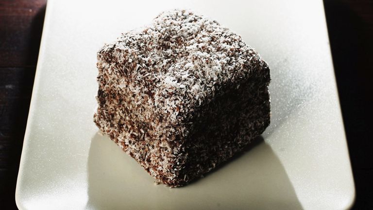 SYDNEY, NSW - JANUARY 25: A Lamington cake is pictured January 25, 2006 in Sydney, Australia. The cake, an Australian specialty, is a cube of plain cake, dipped in melted chocolate and sugar and coated in desiccated coconut. It is said to have been named after Governor General Lord Lamington, a popular governor of Queensland from 1896 to 1901. The nation will celebrate Australia Day on January 26. (Photo Illustration by Ian Waldie/Getty Images)