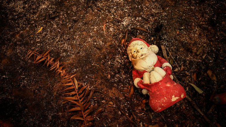 A burnt Christmas decoration lies on the ground in front of a house recently destroyed by bushfires on the outskirts of the town of Bargo on December 21, 2019 in Sydney, Australia