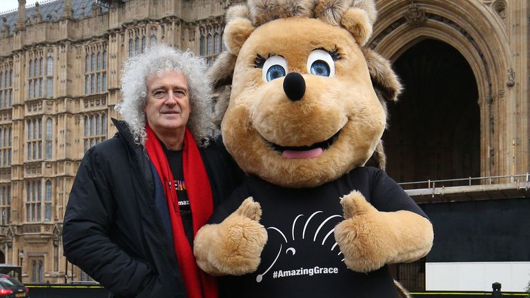 Brian May stands beside Grace the Hedgehog, mascot of the Save Me Trust, in College Green, opposite the Palace of Westminster in London