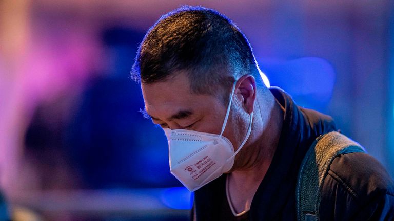 A man wearing a protective mask looks on as she walks outside Beijing railway station in Beijing on January 22, 2020. - A new virus that has killed nine people, infected hundreds and reached the United States could mutate and spread, China warned on January 22, as authorities urged people to steer clear of the city at the heart of the outbreak. (Photo by NICOLAS ASFOURI / AFP) (Photo by NICOLAS ASFOURI/AFP via Getty Images)