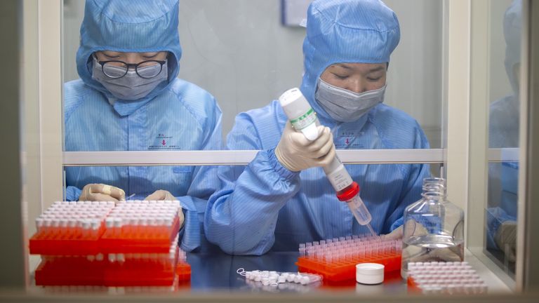 Production workers of Jiangsu Shuoshi Biotechnology Co. Ltd. carry out work on a new coronavirus (2019) nucleic acid detection kit. Pic: Stringer/EPA-EFE/Shutterstock