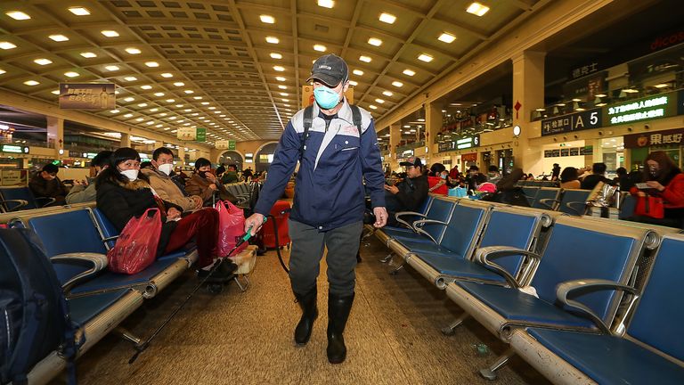 A member of staff disinfecting at Hankou Railway Station in Wuhan