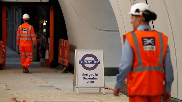 Crossrail employees walk in the new Farringdon underground station of the Elizabeth line which opens in December 2018