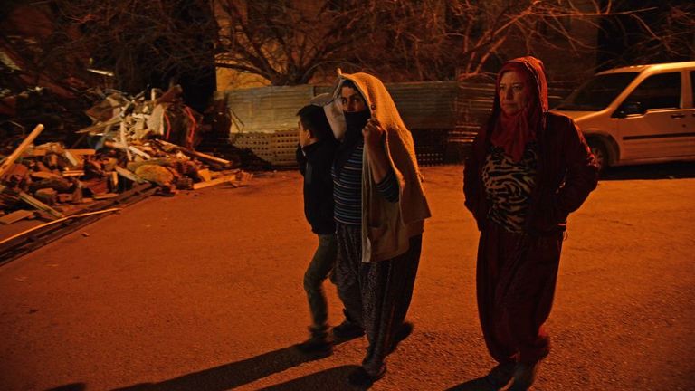 Residents walk on a street as following a 6.8 magnitude earthquake in Elazig
