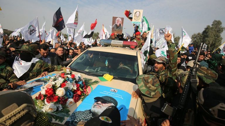 A car carrying the coffin of Iraqi paramilitary chief Abu Mahdi al-Muhandis was surrounded by mourners in Baghdad