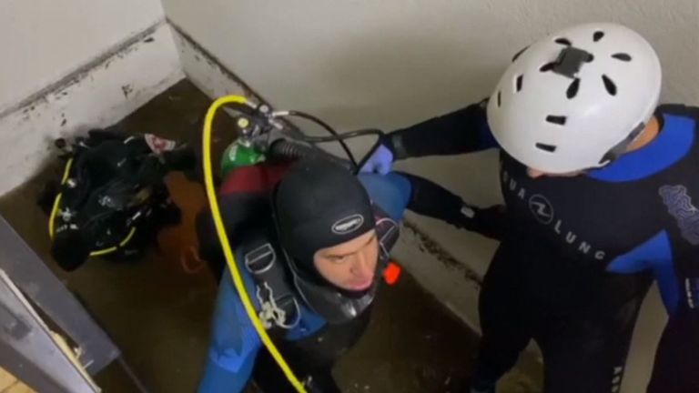 Divers are seen living the flooded car park during the rescue attempt