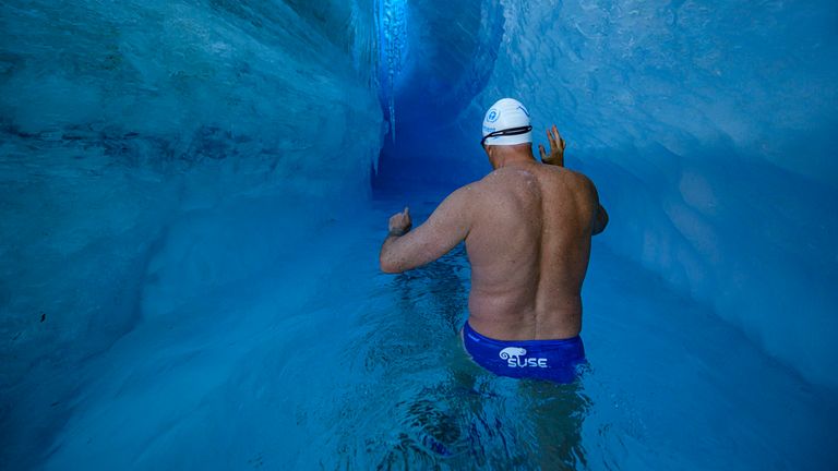 Lewis Pugh became the first person to swim under an Antarctic ice sheet - wearing just a pair of trunks, cap and googles.