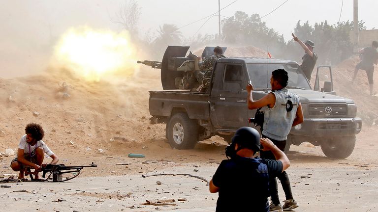 A fighter loyal to the Libyan internationally-recognised government fires a heavy machine gun