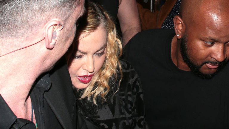 Madonna leaves the London Palladium surrounded by security