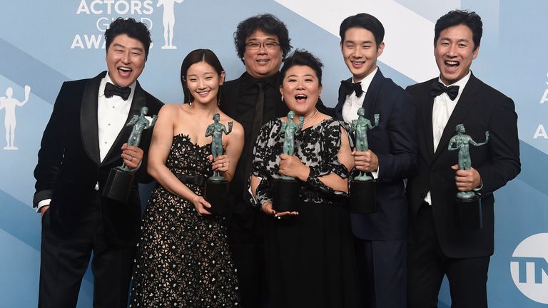 The cast of Parasite - and director Bong Joon Ho (third from the left) - celebrate their win