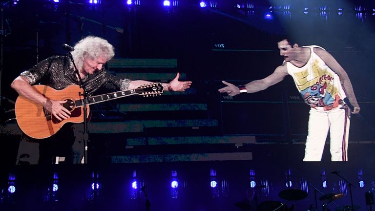 Brian May of Queen performs on stage with Freddie Mercury on screen during the 2019 Global Citizen Festival: Power The Movement in Central Park on September 28, 2019 in New York City