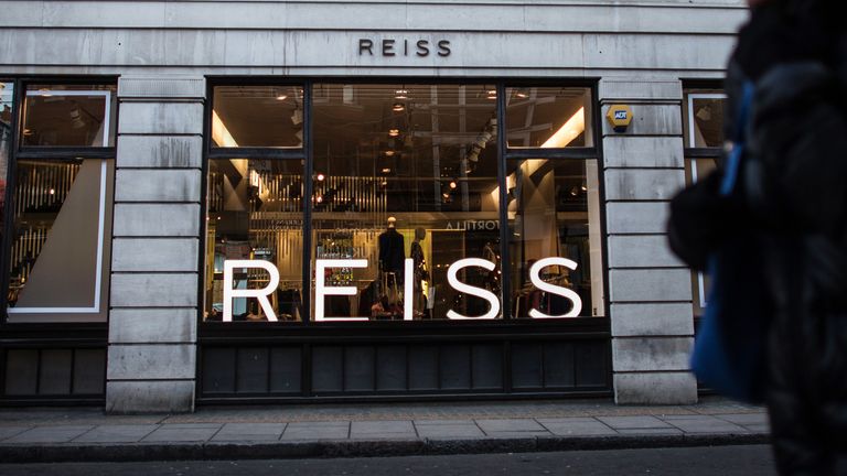 LONDON, ENGLAND - FEBRUARY 15:  A woman walks past a Reiss store on February 15, 2016 in London, England. Investment firm Warburg Pincus, which owns 15 per cent of discount chain Poundland, has expressed an interest following an announcement by company owner David Reiss that he intends to sell a stake in his company.  (Photo by Carl Court/Getty Images)