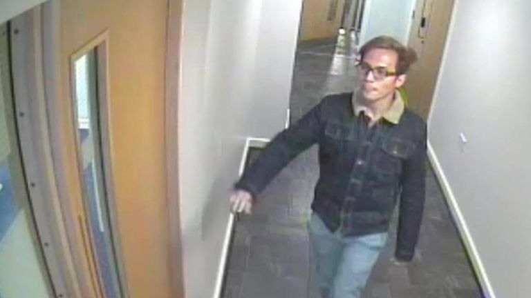 Sinaga is seen on a security camera in the hallway outside his flat