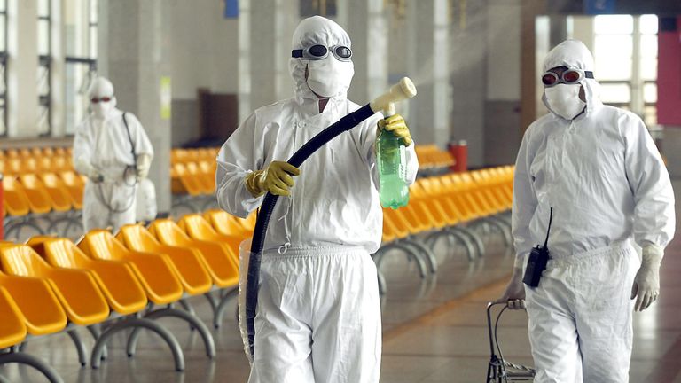 Workers disinfect the waiting room of Beijing railway station during the Sars outbreak in 2003