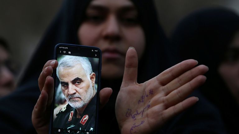 An Iranian woman shows a photo of the late Iranian Major-General Qassem Soleimani, during a protest against the assassination of Soleimani, head of the elite Quds Force, and Iraqi militia commander Abu Mahdi al-Muhandis, who were killed in an air strike at Baghdad airport, in front of United Nation office in Tehran, Iran January 3, 2020