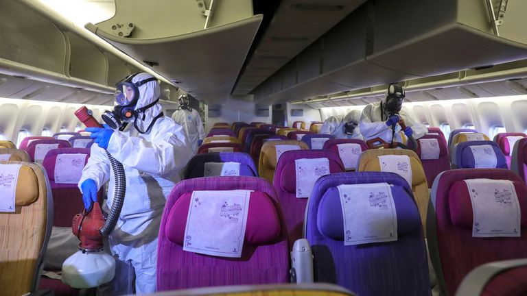 Members of the Thai Airways crew disinfect the cabin of an aircraft of the national carrier during a procedure to prevent the spread of the coronavirus at Bangkok&#39;s Suvarnabhumi International Airport