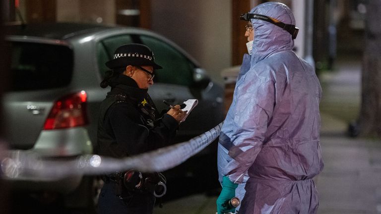 Police and forensics officers at the scene in Seven Kings, northeast London
