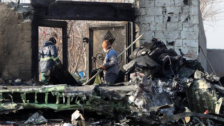 Rescue teams work amidst debris after a Ukrainian plane carrying 176 passengers crashed near Imam Khomeini airport