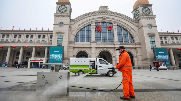 A worker sanitizes the square in front of the Hankou Railway Station, closed after the city of Wuhan was locked down