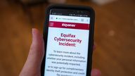 Close-up of the hand of a man holding a mobile phone open to the web site of credit bureau Equifax, with text on the website reading "Equifax Cybersecurity Incident", providing steps for consumers to take following a security breach at the company, San Ramon, California, September 28, 2017. (Photo by Smith Collection/Gado/Getty Images)
