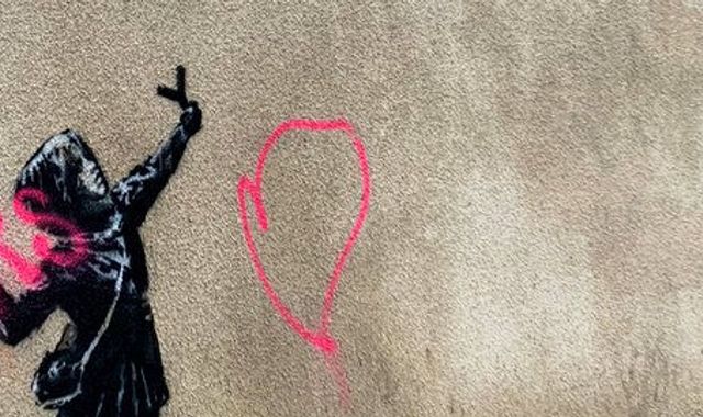 Banksy artwork of girl firing flowers from slingshot is vandalised in Bristol
