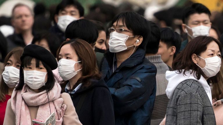TOKYO, JAPAN - FEBRUARY 02: People wearing masks wait to cross a road  in the Shibuya district on February 02, 2020 in Tokyo, Japan. Japan reported 20 cases of Wuhan coronavirus infections as the number of those who have died from the virus, known as 2019-nCoV, in China climbed to over 300 and cases have been reported in other countries including the United States, Canada, Australia, Japan, South Korea, India, the United Kingdom, Germany, France, and several others.  (Photo by Tomohiro Ohsumi/Getty Images)