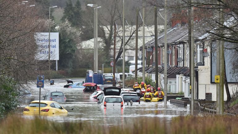 A member of the public is rescued from a flooded house in Oxford Street in Nantgarw, Wales as Storm Dennis hit the UK.