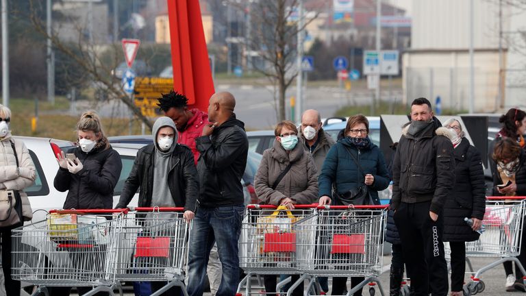 People queue at a supermarket outside the town of Casalpusterlengo, which has been closed by the Italian government due to a coronavirus outbreak in northern Italy, February 23, 2020. REUTERS/Guglielmo Mangiapane