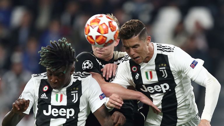 TOPSHOT - Juventus' Italian forward Moise Kean (L) and Juventus' Portuguese forward Cristiano Ronaldo go for a header during the UEFA Champions League quarter-final second leg football match Juventus vs Ajax Amsterdam on April 16, 2019 at the Juventus stadium in Turin. (Photo by Isabella BONOTTO / AFP)        (Photo credit should read ISABELLA BONOTTO/AFP via Getty Images)