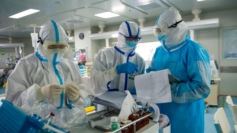 This photo taken on February 22, 2020 shows medical staff checking notes in an intensive care unit treating COVID-19 coronavirus patients at a hospital in Wuhan, in China&#39;s central Hubei province. - China on February 26 reported 52 new coronavirus deaths, the lowest figure in more than three weeks, bringing the death toll to 2,715. (Photo by STR / AFP) / China OUT (Photo by STR/AFP via Getty Images)