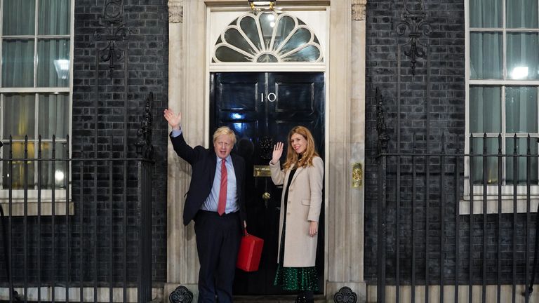 LONDON, ENGLAND - DECEMBER 13: Prime Minister Boris Johnson and his partner Carrie Symonds enter Downing Street as the Conservatives celebrate a sweeping election victory on December 13, 2019 in London, England. Prime Minister Boris Johnson called the first UK winter election for nearly a century in an attempt to gain a working majority to break the parliamentary deadlock over Brexit. As the results roll in the Conservative Party has gained the number of seats needed to win a clear majority at the expense of the Labour Party. Votes are still being counted and an overall result is expected later today. (Photo by Peter Summers/Getty Images)