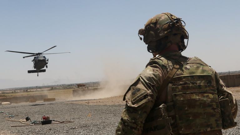 A US soldier watches as a Blackhawk helicopter prepares to land in southeastern in August 2019