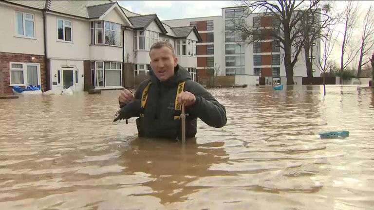 Sky&#39;s Alex Rossi up to his waist in flood water on a Hereford street