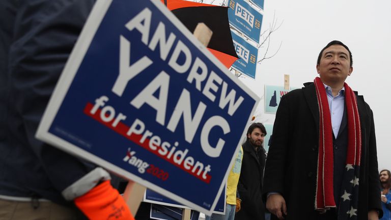 Democratic presidential candidate Andrew Yang greets supporters in who are holding signs in front of a polling station on February 11, 2020 in Keene, New Hampshire
