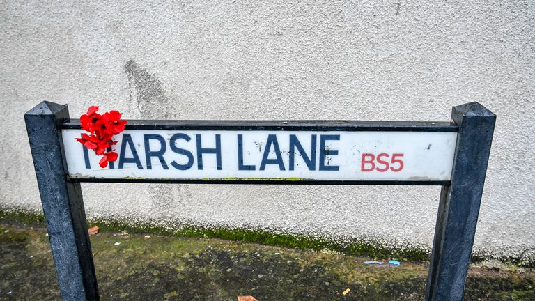 Red flowers also appear on a sign in Marsh Lane