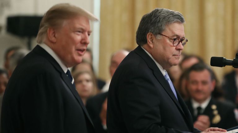 President Donald Trump (L) stands with Attorney General William Barr 