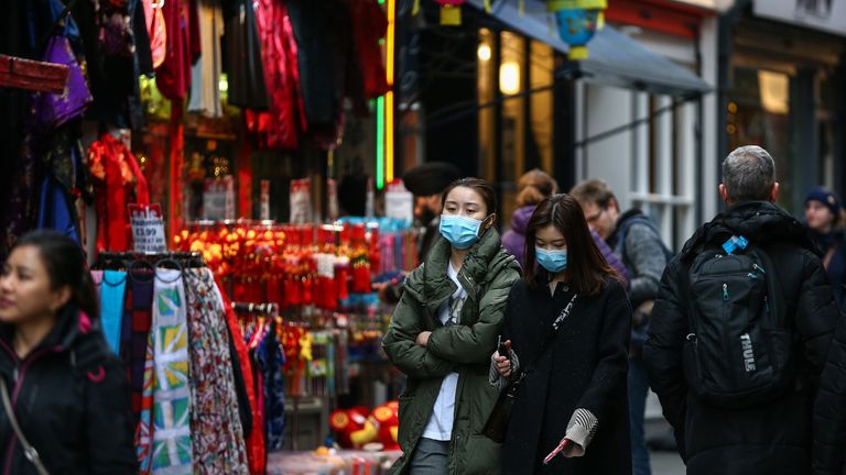 Women wear face masks in London