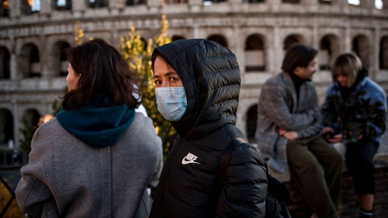 Chinese tourists wearing face masks visit the Colosseum area on February 6, 2020 in Rome, Italy