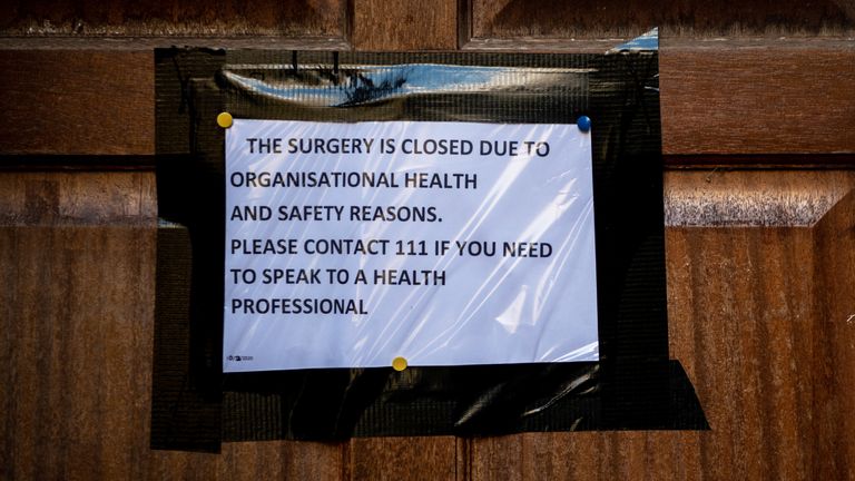 A sign on the front door of a surgery in Brighton closed over coronavirus fears