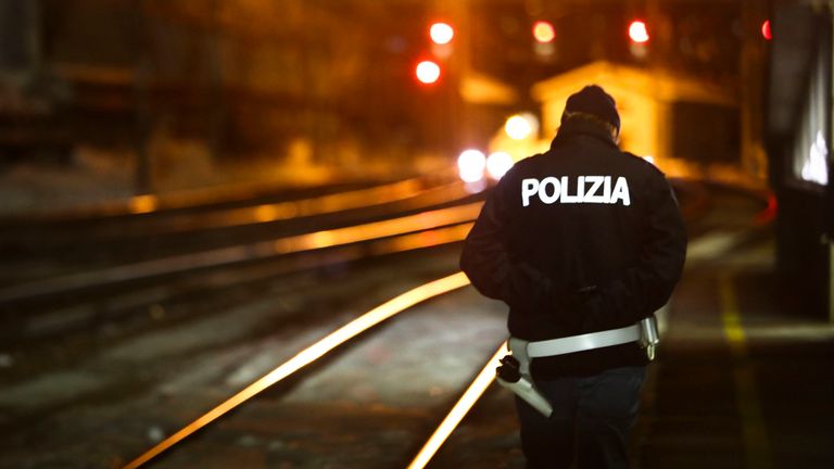 A police officer patrols on a platform at the train station on the Italian side of the Brenner Pass, Italy