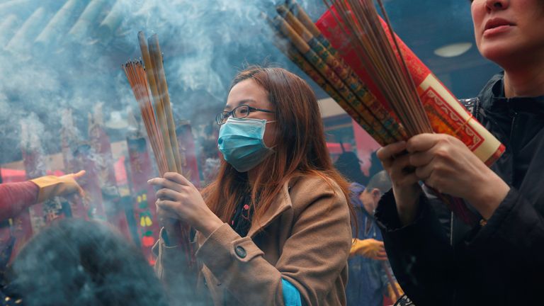 Worshippers wear masks at Che Kung Temple in Hong Kong