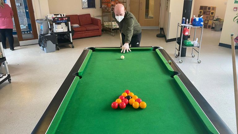 Kharn Lambert plays pool inside the coronavirus quarantine in Merseyside