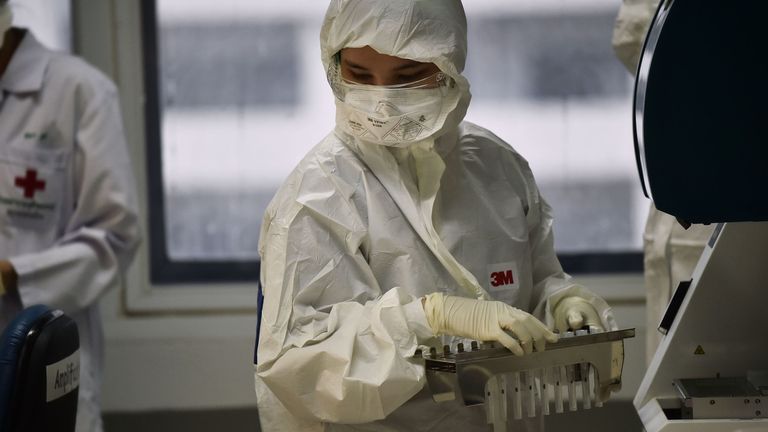 Lab technicians test patient samples for the novel coronavirus at the Centre for Emerging Infectious Diseases of Thailand at Chulalongkorn University in Bangkok on February 5, 2020. - Thailand so far has detected 25 confirmed cases of the novel coronavirus believed to have originated in the central Chinese city of Wuhan, which is under lockdown.