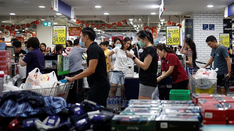 People stock up on food supplies after Singapore raised coronavirus outbreak alert to orange, at a supermarket in Singapore