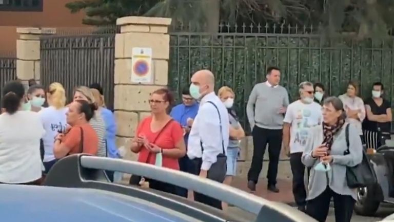 Hotel guests outside coronavirus affected hotel.