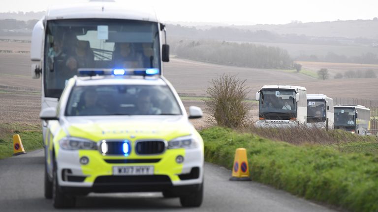 The passengers are escorted by police to Arrowe Park Hospital on the Wirral