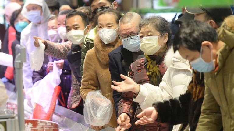 Shoopers in protective masks at a supermarket in Wuhan