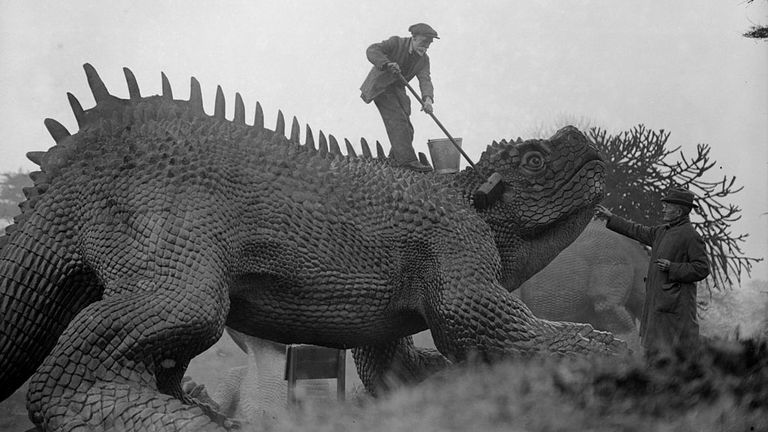 One of the sculptures gets an annual scrub in February 1927