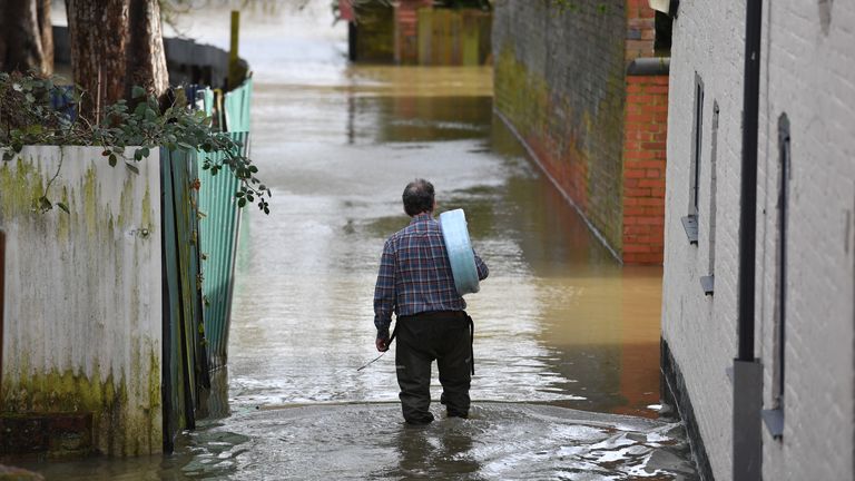 A man wades back to his property in Shrewsbury 